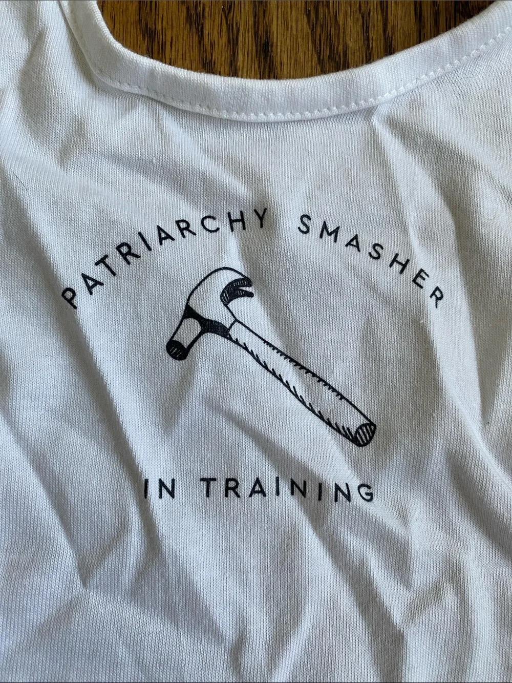 Rabbit Skins White Baby Bib with 'Patriarchy Smasher' Hammer Graphic, like new.